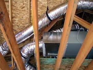 Exposed ductwork running through an attic