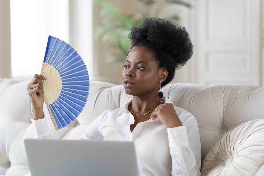 woman sitting fanning herself