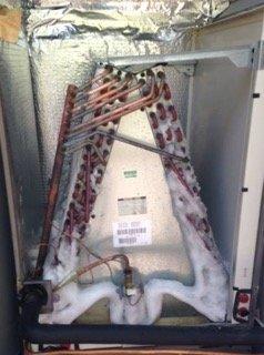 A closeup photo of evaporator coils covered with ice.